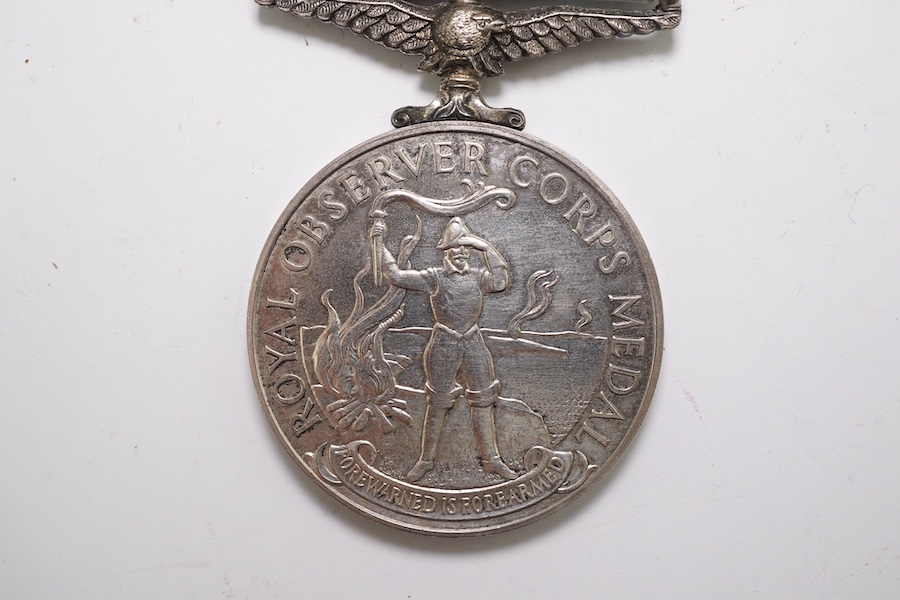 An ERII (B) Royal Observer Corps medal to Observer W.Cook with a lapel badge. Condition - fair.